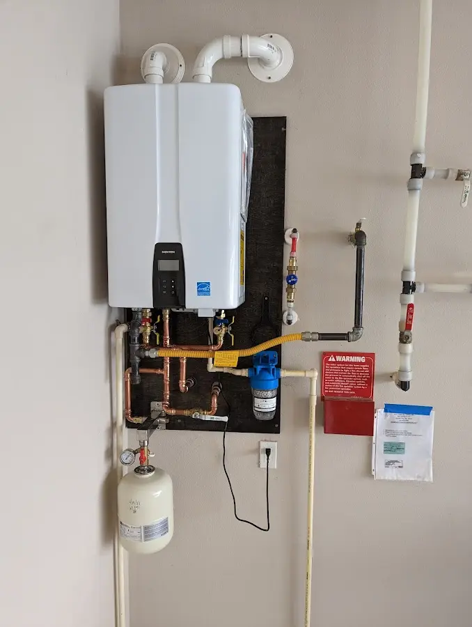 Professional plumber installing copper piping in a Schenectady home